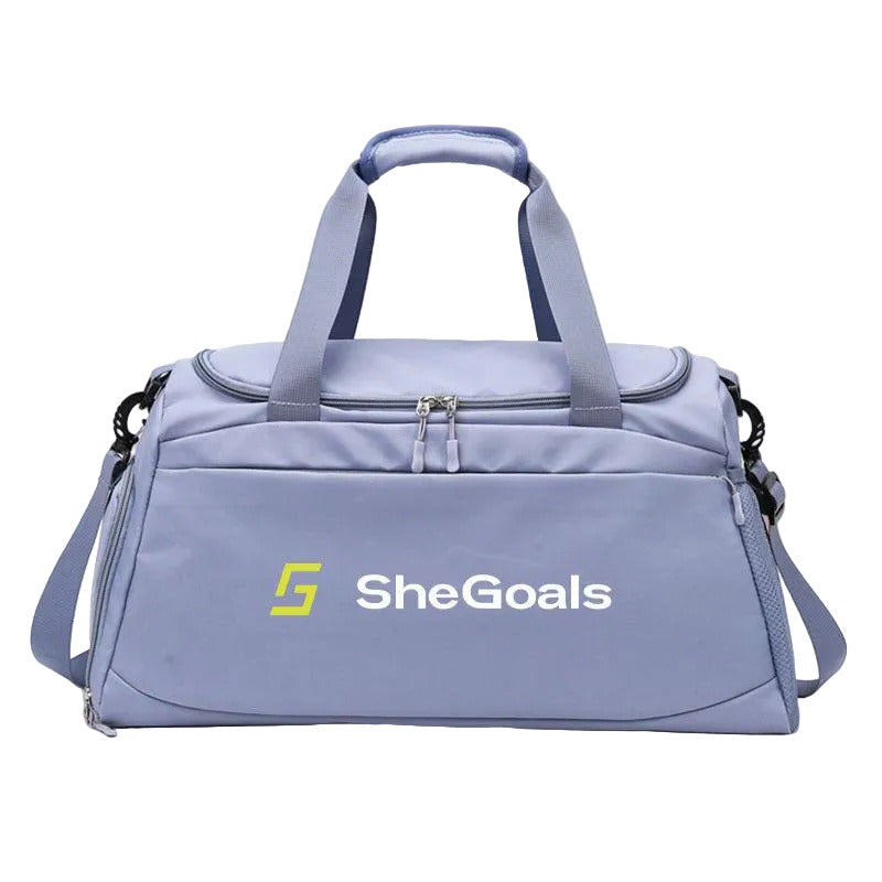 Blue duffel bag with 'SheGoals' logo on a pink background